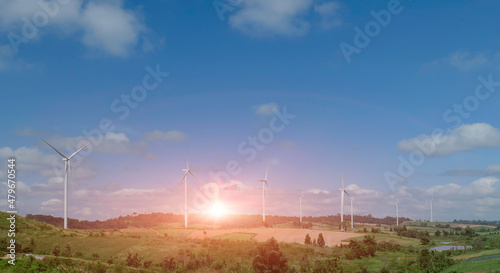 Eco power, landscape with hills and wind turbine field on sunset sky background.