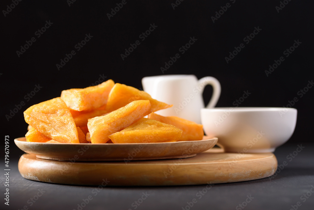 Deep fried Burmese tofu made from flour and chickpeas on black background Deep fried Burmese tofu made from flour and chickpeas on black background