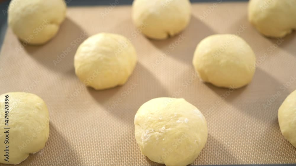 Step by step. Rising brioche dough on a baking sheet with a silicone mat. Step by step. Rising brioche dough on a baking sheet with a silicone mat.