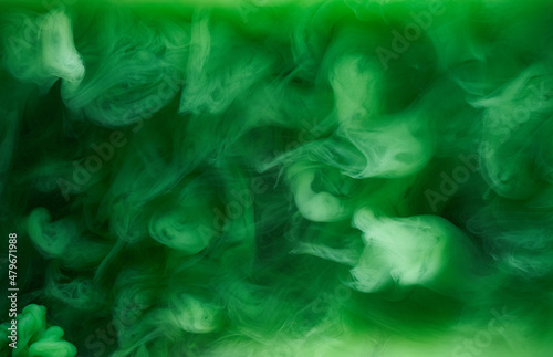 Green smoke on black ink background, colorful fog, abstract swirling emerald ocean sea, acrylic paint pigment underwater
