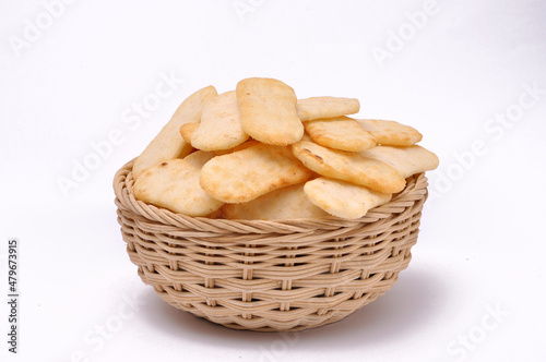 Spicy rice cracker in a bamboo bowl with isolated white background