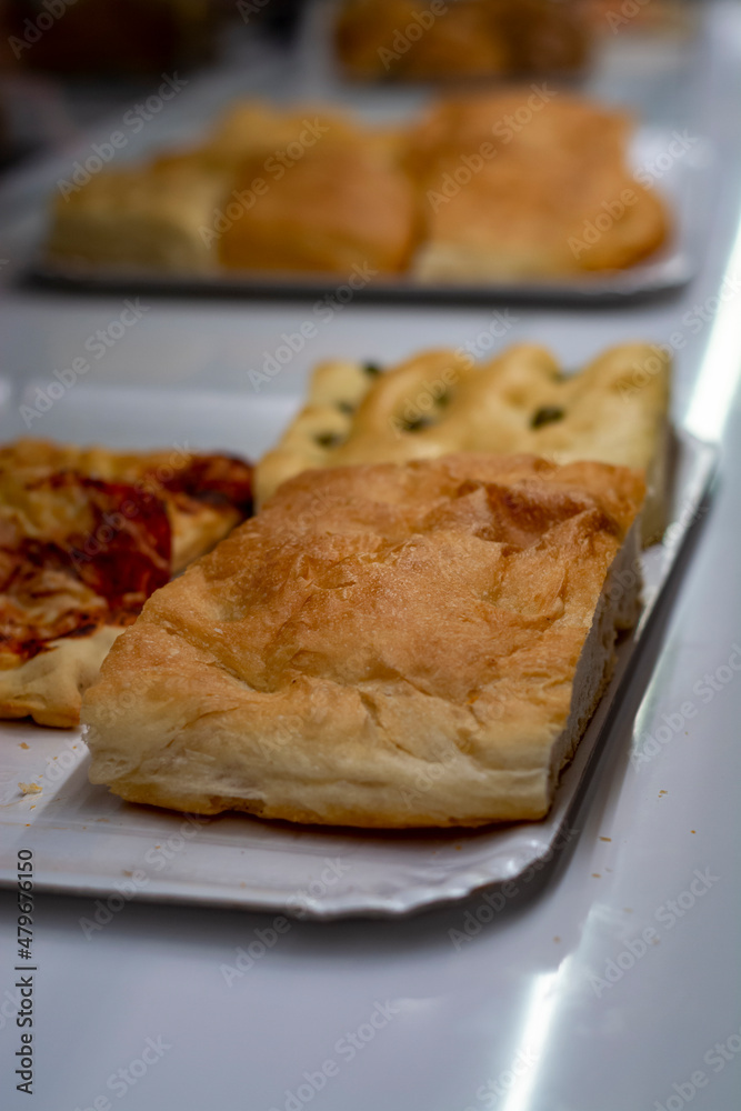 Fresh baked pastry pie and pizzas in small bakery in Parma, Emilia Romagna, Italy