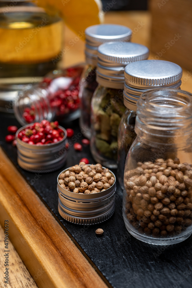 Professional set of gin spices in small bottles, pink pepper, hibiscus flowers, juniper berries, cardamom and coriander seeds Professional set of gin spices in small bottles, pink pepper, hibiscus flowers, juniper berries, cardamom and coriander seeds