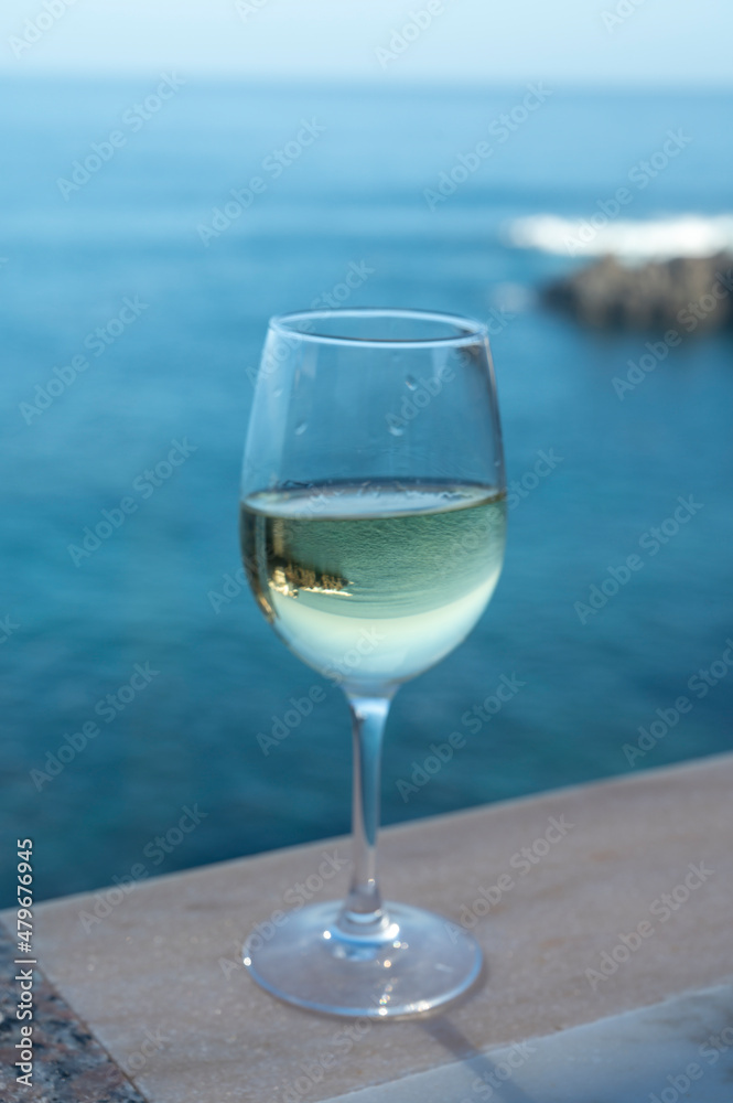 Drinking of white wine with view on blue Atlantic ocean on Tenerife, Canary islands, Spain Drinking of white wine with view on blue Atlantic ocean on Tenerife, Canary islands, Spain