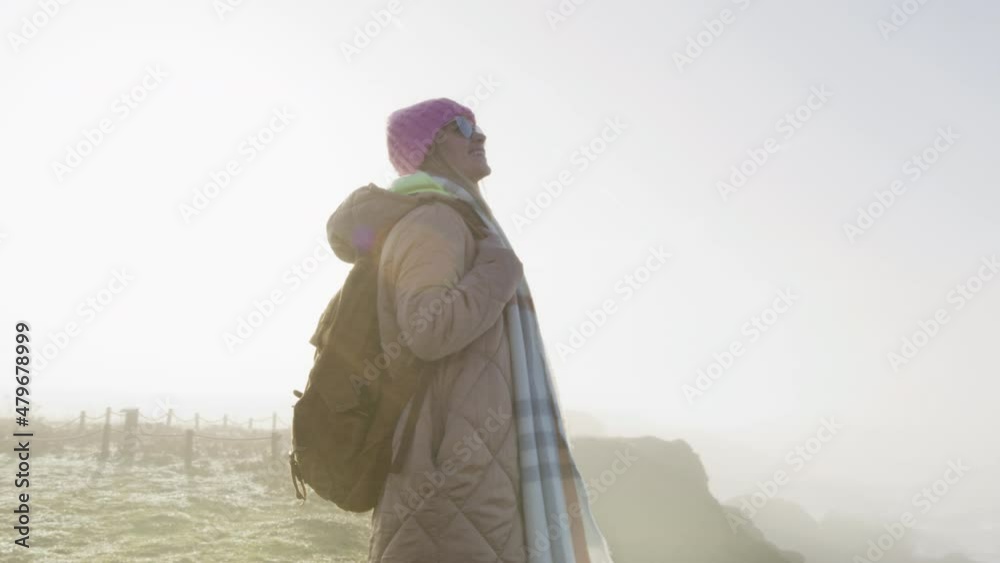 Happy people, feeling freedom, satisfied by travel lifestyle. RED shot. Slow motion young smiling positive attractive woman in casual outfit with backpack looking around, enjoying sunny early morning Happy people, feeling freedom, satisfied by travel lifestyle. RED shot. Slow motion young smiling positive attractive woman in casual outfit with backpack looking around, enjoying sunny early morning