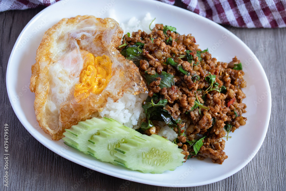 Stir-fried basil with minced pork and fried egg, popular Thai food. Stir-fried basil with minced pork and fried egg, popular Thai food.