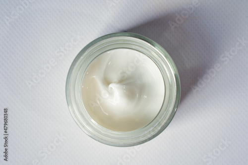 Cosmetic moisturizing anti wrinkle white cream in glass jar on white background