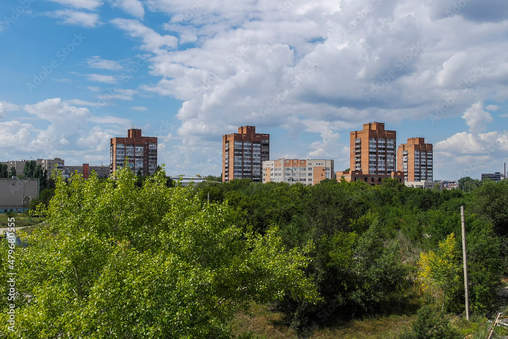 View of the city of Ust-Kamenogorsk (kazakhstan). Old residential area. Soviet built multistory apartment buildings. Green trees and blue sky