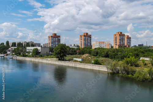 View of the city of Ust-Kamenogorsk (kazakhstan). Old residential area. Soviet built multistory apartment buildings. Irtysh river. Green trees and blue sky