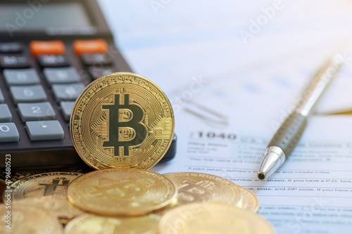 Bitcoin on a calculator and individual income tax return form 1040. tax for the trading of crypto-currencies.The time to pay taxes concept.