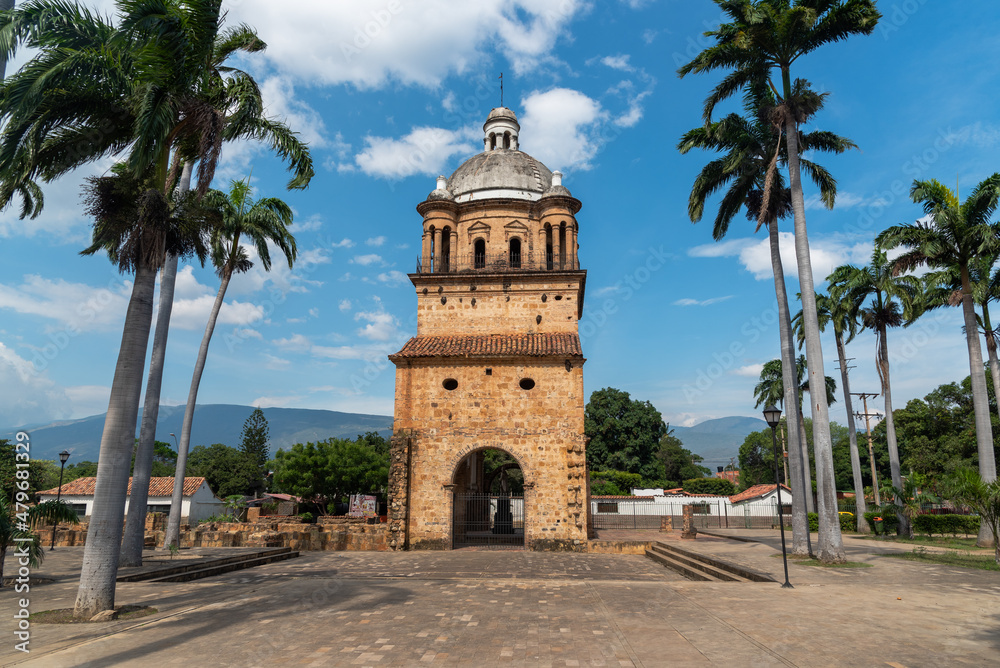 Fototapeta premium Bell tower of the historic temple of Villa del Rosario surrounded by palm trees. Cucuta. Colombia