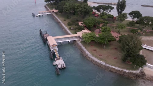 Empty Pier At Kusu Island, Tortoise Island In Singapore. - aerial tilt up photo