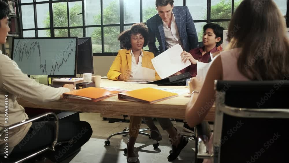 The company staff, group of multiracial workers work with computers and team brainstorming at the open workspace, talking and discussing with a Caucasian male boss at the marketing business office. The company staff, group of multiracial workers work with computers and team brainstorming at the open workspace, talking and discussing with a Caucasian male boss at the marketing business office.