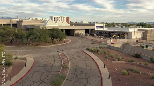 Closed Convention Center in Tucson Arizona, cracked asphalt, drone ascend. photo