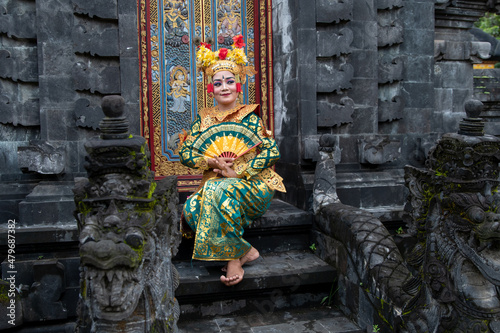 Balinese dancer woman in gold costume, Temple Bali Indonesia