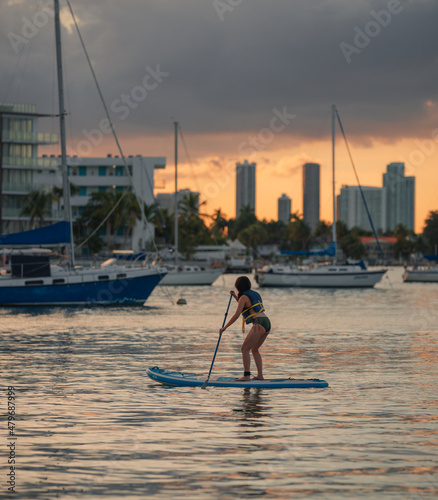 silhouette of a person in a kayak on the beach Miami Florida 