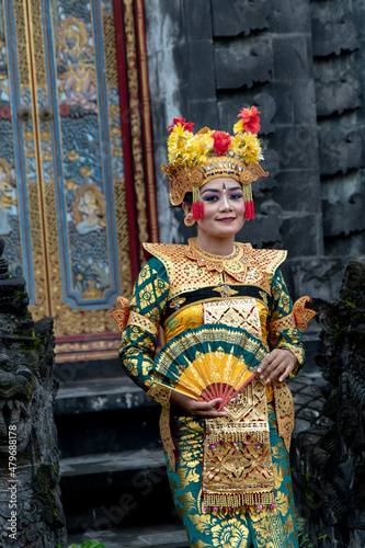 Portrait of a Balinese dancer in a golden costume.