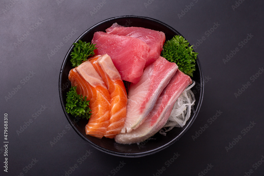 Top view of Sashimi Set (Raw Salmon, Hamachi and Bluefin Tuna) sliced and put together in a black bowl and ready to served. Popular Japanese food. Top view of Sashimi Set (Raw Salmon, Hamachi and Bluefin Tuna) sliced and put together in a black bowl and ready to served. Popular Japanese food.
