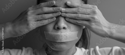 woman with mouth sealed in adhesive tape. Free of speech, freedom of press, Human rights, Protest dictatorship, democracy, liberty, equality and fraternity concepts photo