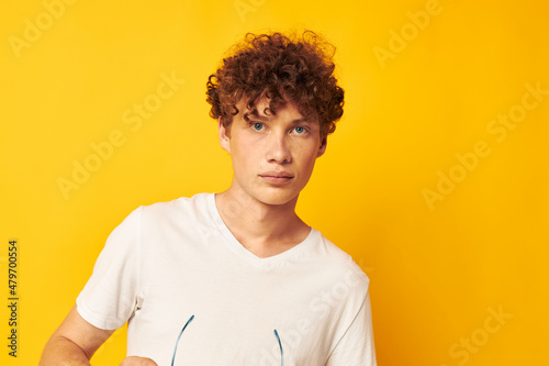 portrait of a young curly man Youth style glasses posing isolated background unaltered
