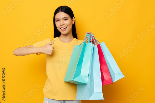 woman with Asian appearance fashion shopping posing isolated background unaltered
