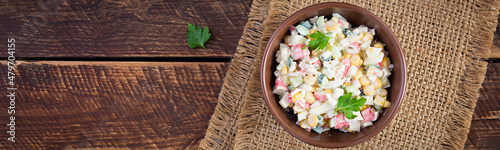 Fotografie, Obraz Salad with corn and crab sticks in bowl on wooden table