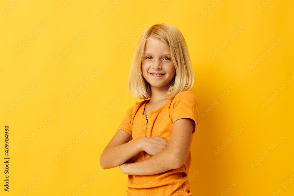 cute little girl in a yellow t-shirt smile posing studio color background unaltered cute little girl in a yellow t-shirt smile posing studio color background unaltered