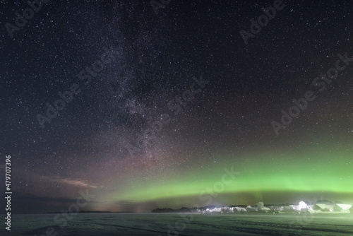 Starry sky and polar lights over frozen Lake Onega in the first days of the new year