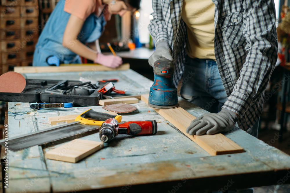 Man and woman working in workshop, doing furniture, reuse old materials to new product. awareness in consumption. Small family business. Recycling, sustainability refurbishments maintenance for home