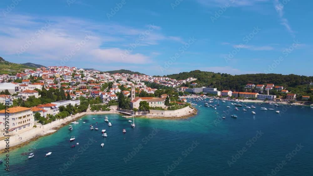 Panorama of a coastal town with many houses with red roofs, surrounded by the sea and mountains Panorama of a coastal town with many houses with red roofs, surrounded by the sea and mountains