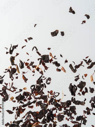 Dry tea leaves isolated on a white background.