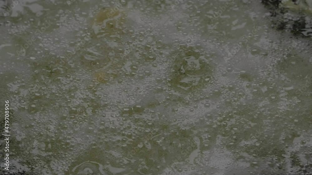 Slow motion shot of cooking oil boiling in a shallow pan
Slow motion shot of cooking oil boiling in a shallow pan