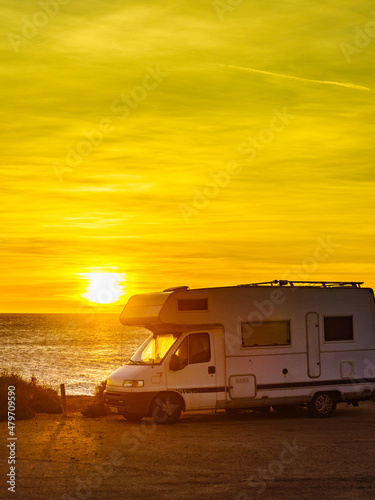 Camper car on beach at sunrise