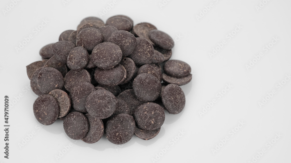 Fototapeta premium Dark chocolate chips on white background. Chocolate chips. Confectionery concept