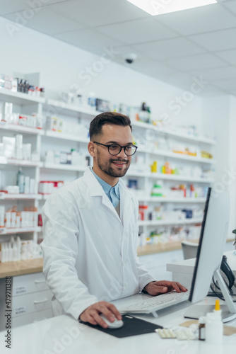 Portrait of a handsome pharmacist working in a pharmacy