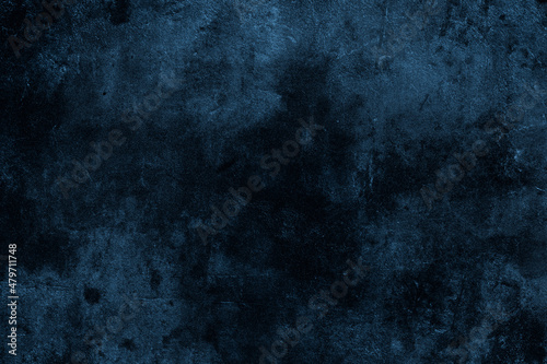 Dark moody blue color old cement plaster wall with spots and grunge textures for background