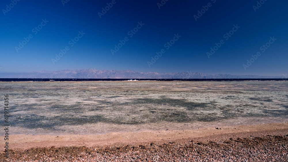 Beautiful red sea view with mountains and cloudy sky at dawn