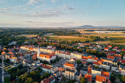 Fototapeta Naklejka Na Ścianę i Meble -  Aerial view of suburban neighborhood, Residential district with buildings and streets at small european town at sunset