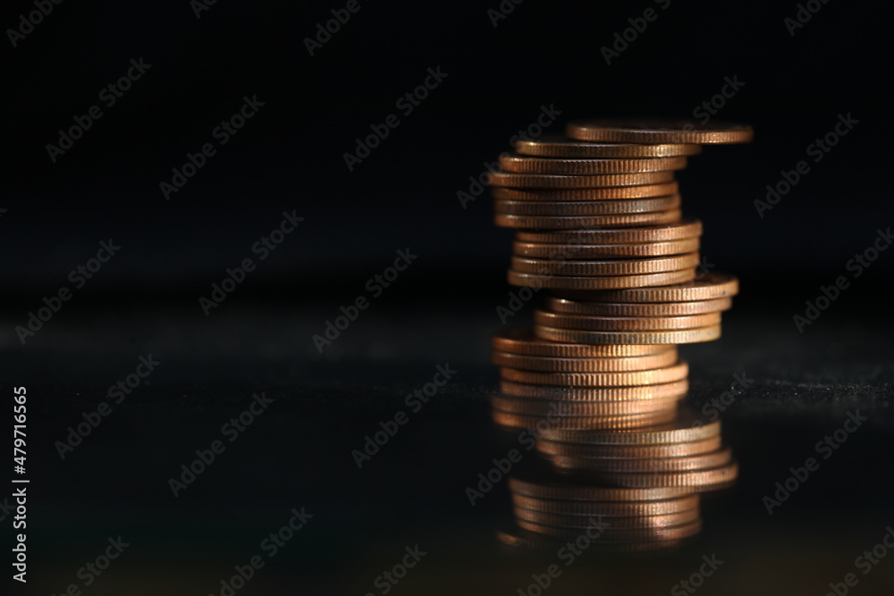 A vertical shot of a pile of golden coins and copper coins. A vertical shot of a pile of golden coins and copper coins.