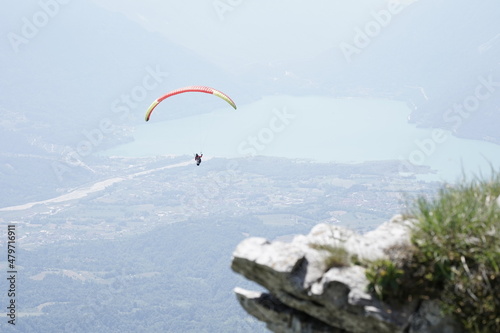 paraglider in flight on the lake