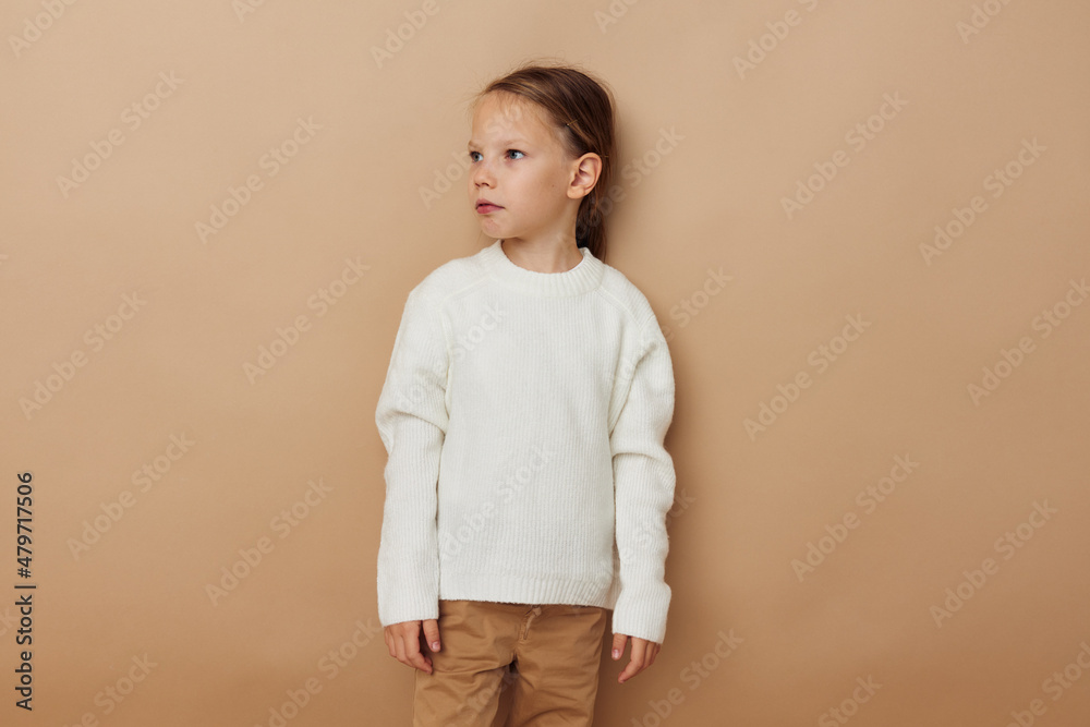 little girl in white sweater posing hand gestures Lifestyle unaltered little girl in white sweater posing hand gestures Lifestyle unaltered