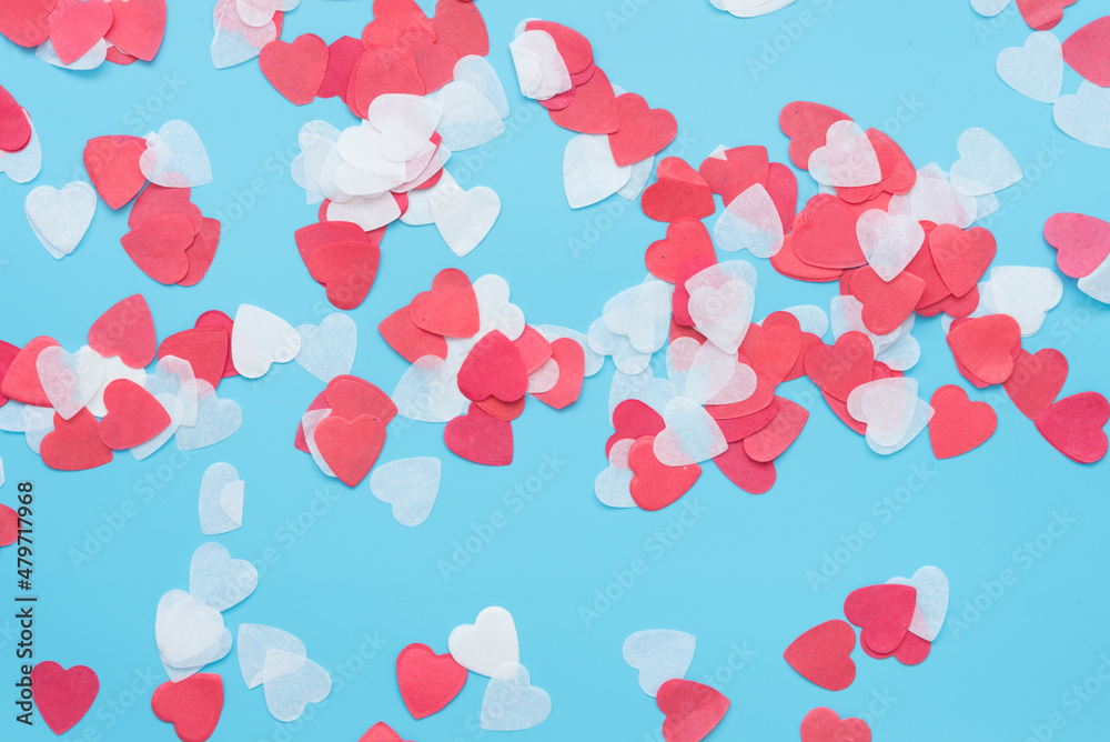 Red and white hearts on a blue background. Background, texture for valentine's day card, wedding day or engagement.