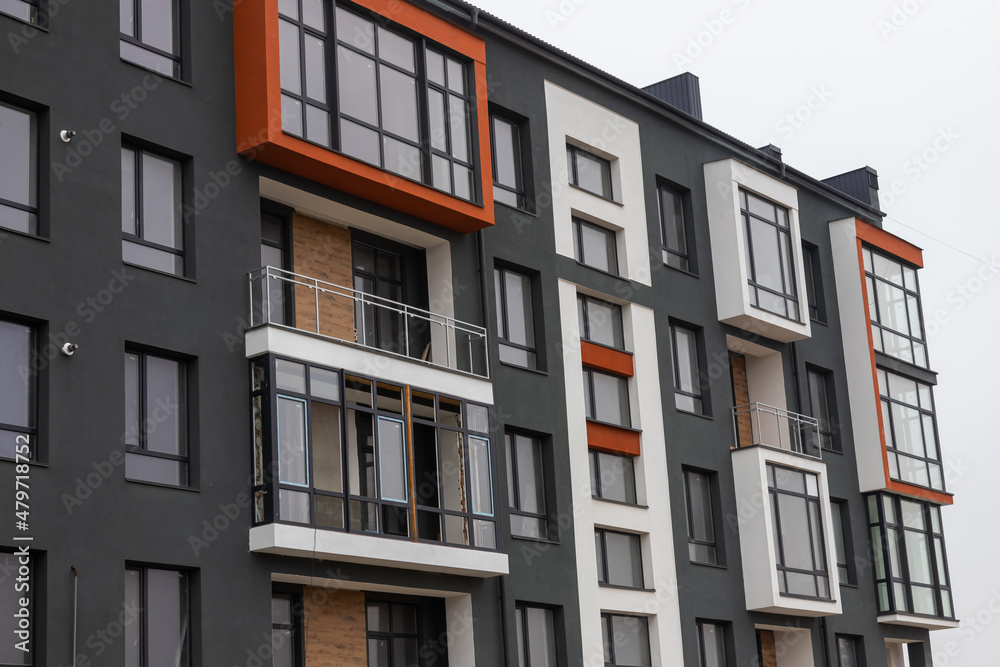 Obraz premium Fragment of Modern residential apartment with flat buildings exterior. Detail of New luxury house and home complex. Part of City Real estate property and condo architecture. Copy space