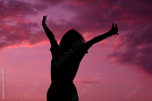 Silhouette medium shot of Woman or female standing with the sky sunset background