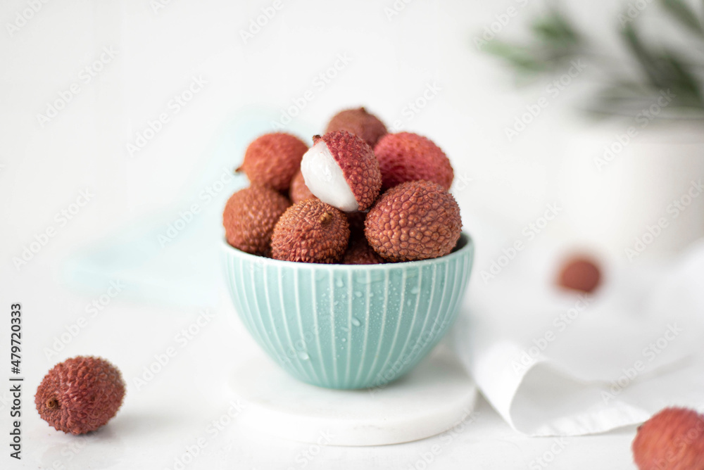 large ripe lychees fruit in a turquoise bowl large ripe lychees fruit in a turquoise bowl
