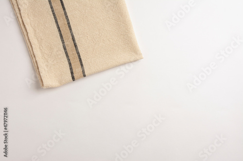 Stripped kitchen towel isolated on white background. Top view of folded linen napkin isolated on white. linen napkin isolated on white background, top view. 