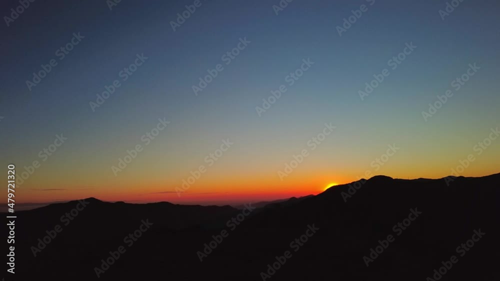 Sunset in the hills from a cross on top of a mountain Sunset in the hills from a cross on top of a mountain