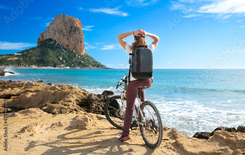 Obraz na plátně woman with bike enjoying view of mediterranean sea- Calp,  Costa brava in Spain