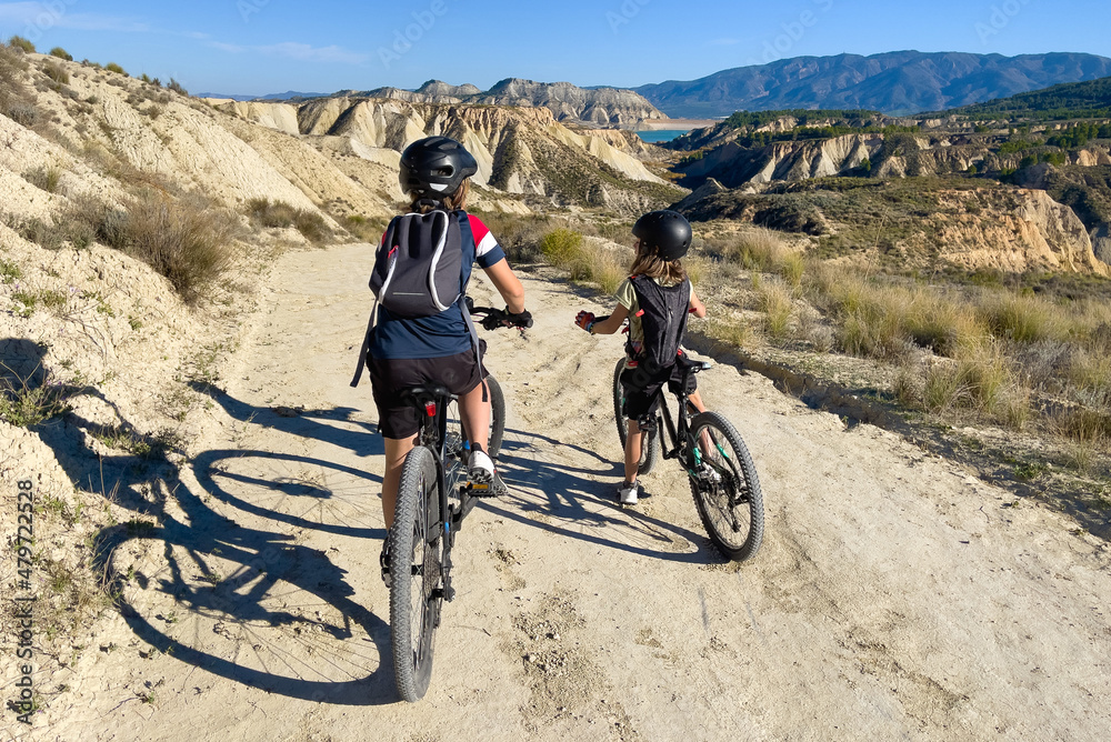 children riding mountain bike in countryside children riding mountain bike in countryside