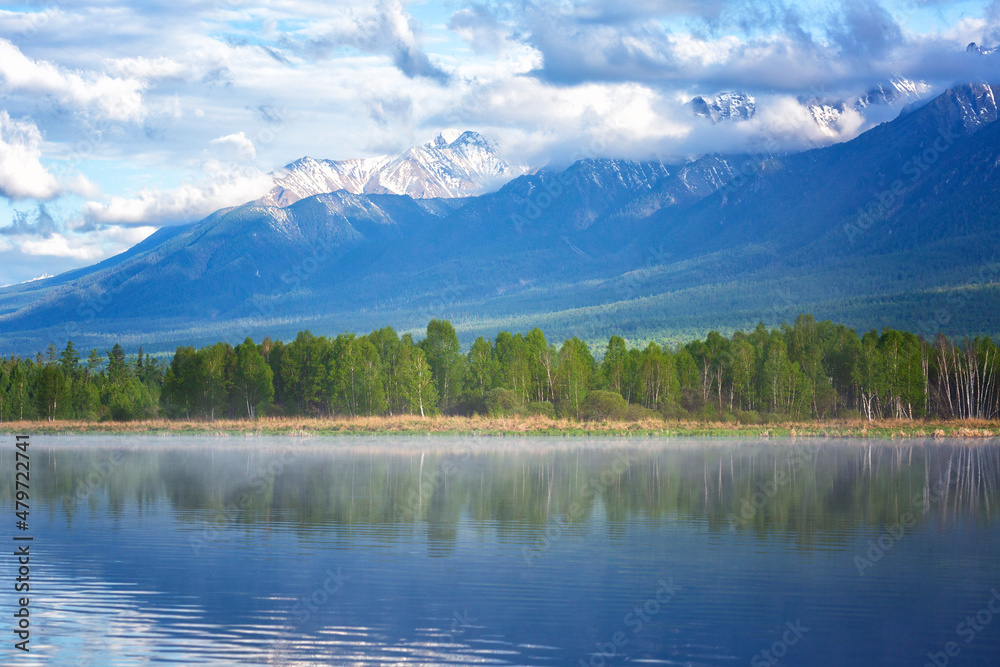 Landscape with mountains reflecting in the water on summer day. Buryatia, Tunkinskaya valley